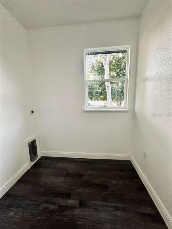 121 Argyle Avenue Frostproof, FL 33843 - Photo 17 of 26 an empty room with wooden floor and windows