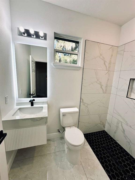 121 Argyle Avenue Frostproof, FL 33843 - Photo 20 of 26 a bathroom with a sink toilet and shower