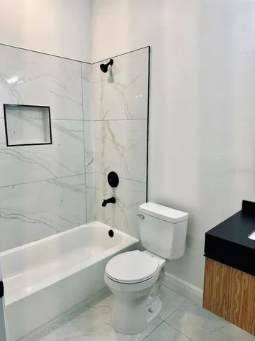a bathroom with a toilet and a bath tub