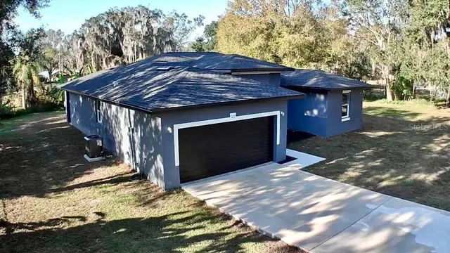 a view of a backyard with large trees