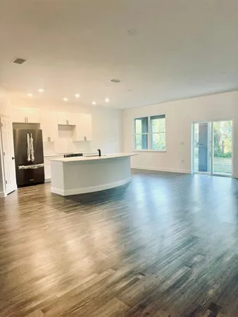 a living room with hard wood floors and a wooden floor
