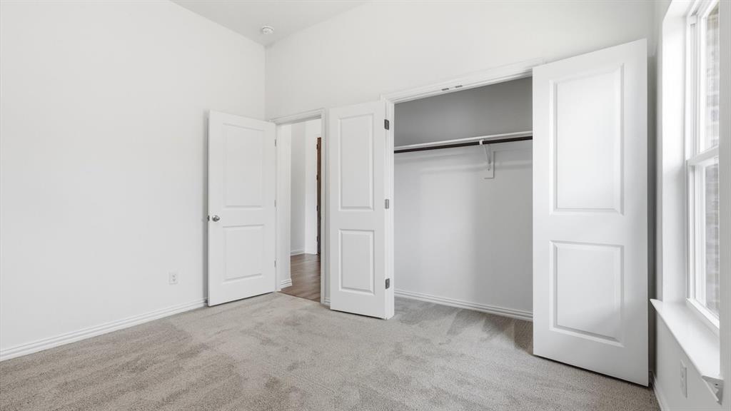 2529 Rivers W Road Anna, TX 75409 - Photo 14 of 40 Room featuring light gray carpeting, white walls, and a window with white trim