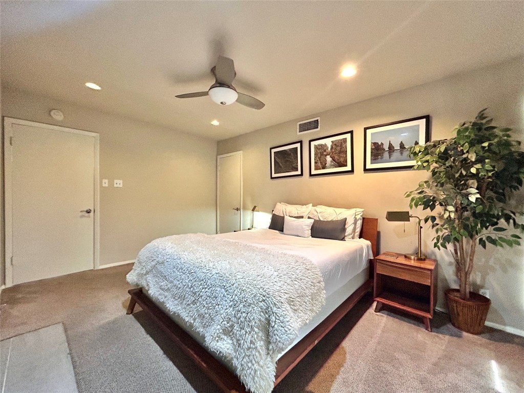 1106 West 6th Street, Unit 205 Austin, TX 78703 - Photo 19 of 27 Bedroom featuring light carpet, a ceiling fan, and recessed lighting