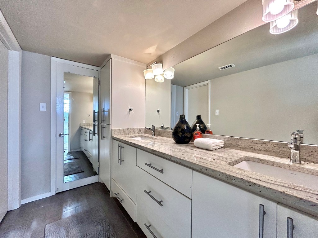 1106 West 6th Street, Unit 205 Austin, TX 78703 - Photo 22 of 27 Full bathroom with double vanity and baseboards