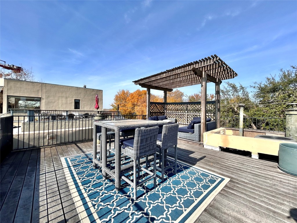 1106 West 6th Street, Unit 205 Austin, TX 78703 - Photo 25 of 27 Wooden rooftop deck featuring outdoor dining space