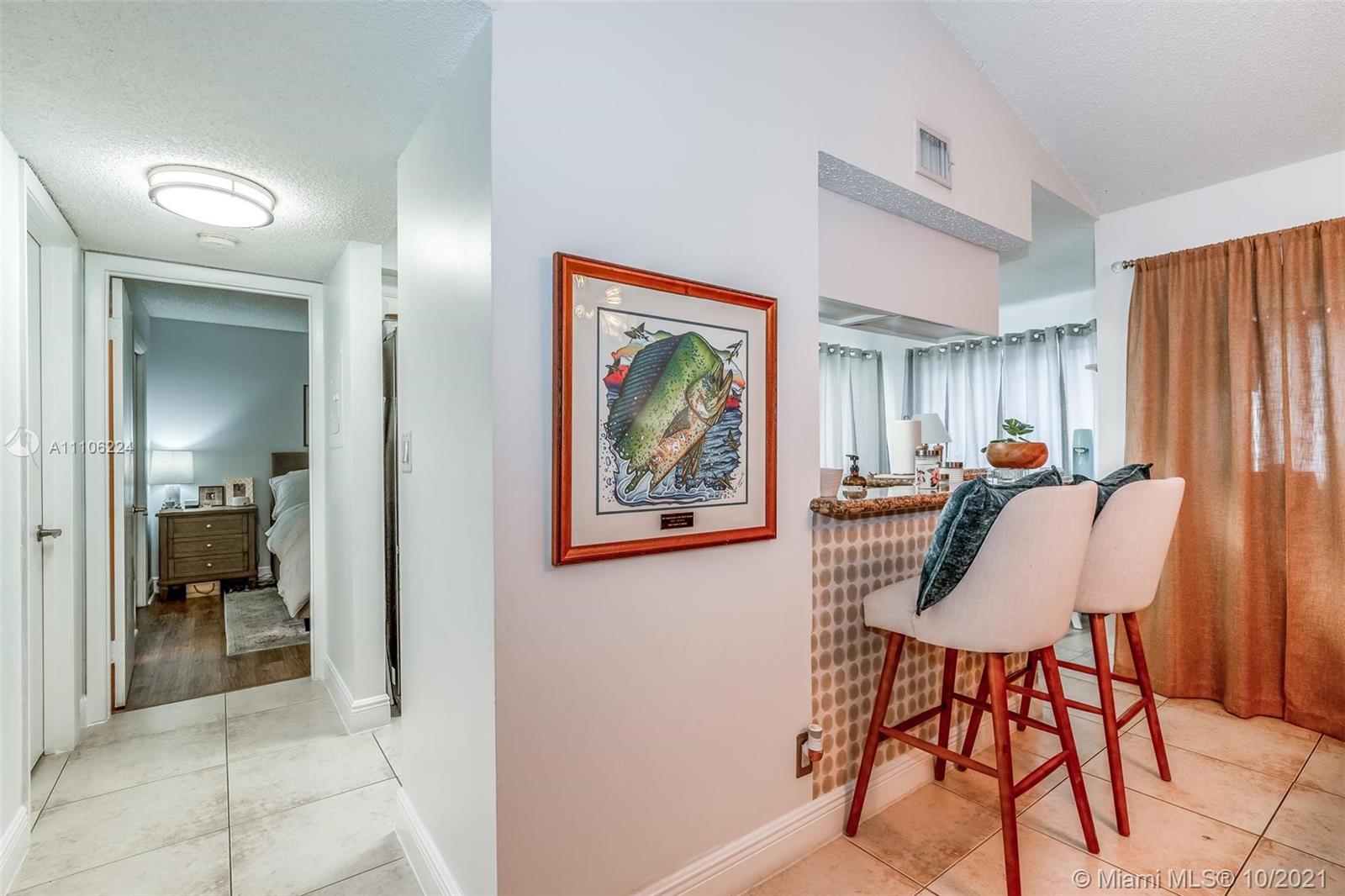 5720 Rock Island Road, Unit 391 Tamarac, FL 33319 - Photo 13 of 27 a view of a workspace with furniture and a livingroom