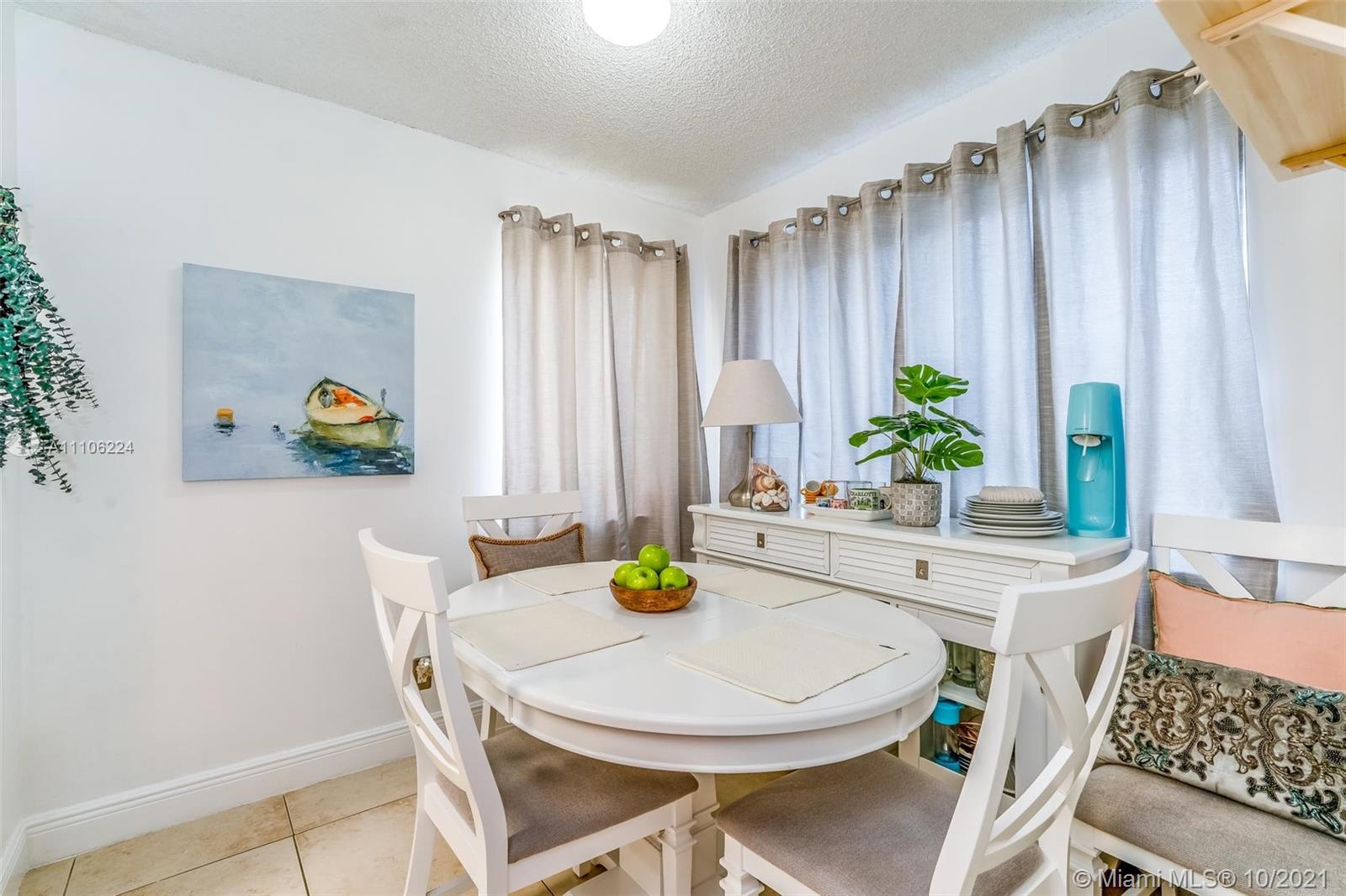 5720 Rock Island Road, Unit 391 Tamarac, FL 33319 - Photo 14 of 27 a dining room with furniture and a potted plant
