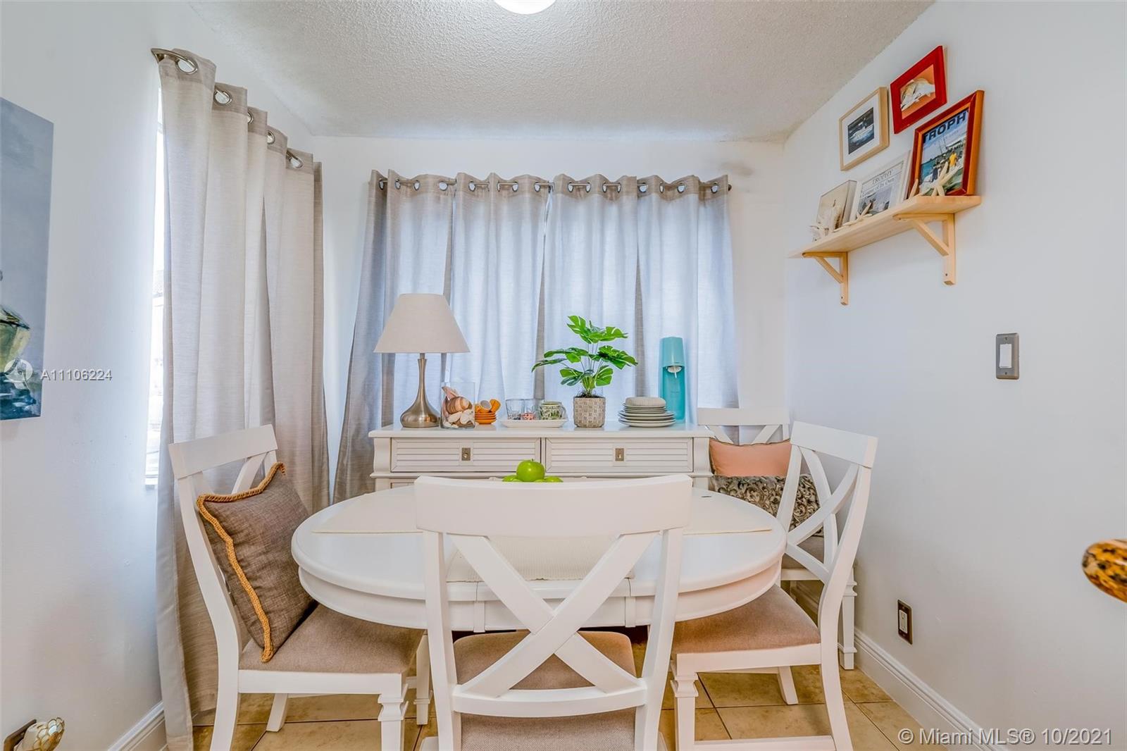 5720 Rock Island Road, Unit 391 Tamarac, FL 33319 - Photo 15 of 27 a view of a dining room with furniture window and wooden floor