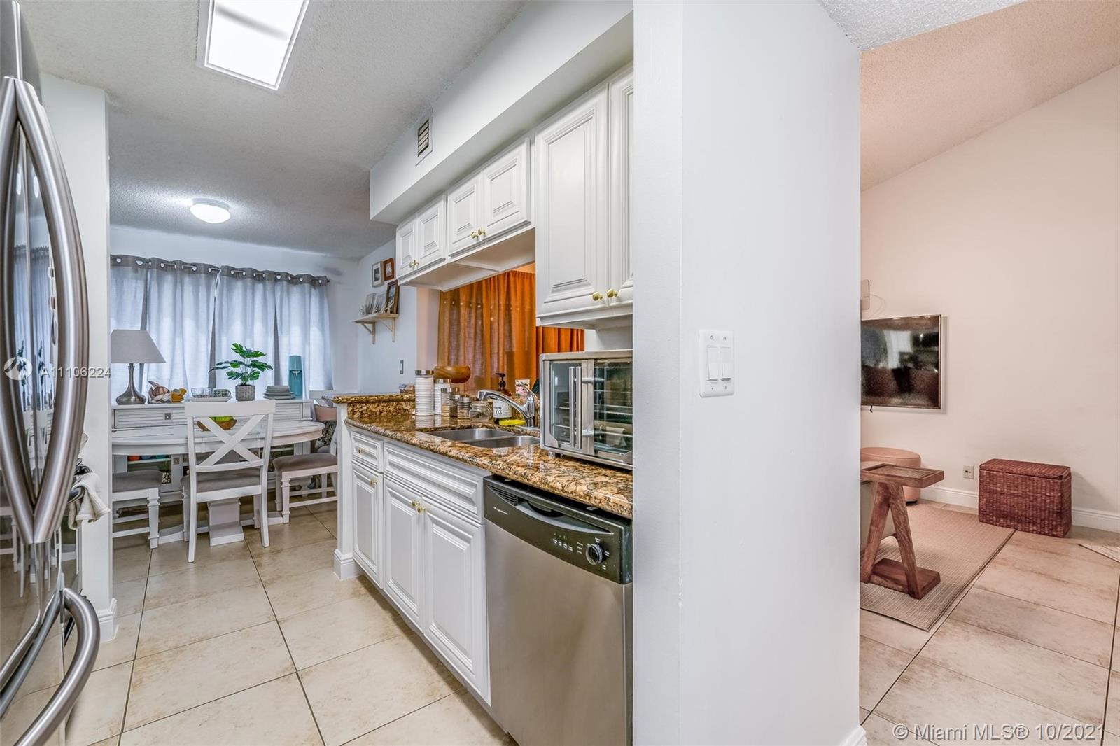 5720 Rock Island Road, Unit 391 Tamarac, FL 33319 - Photo 17 of 27 a kitchen with lots of counter top space and stainless steel appliances
