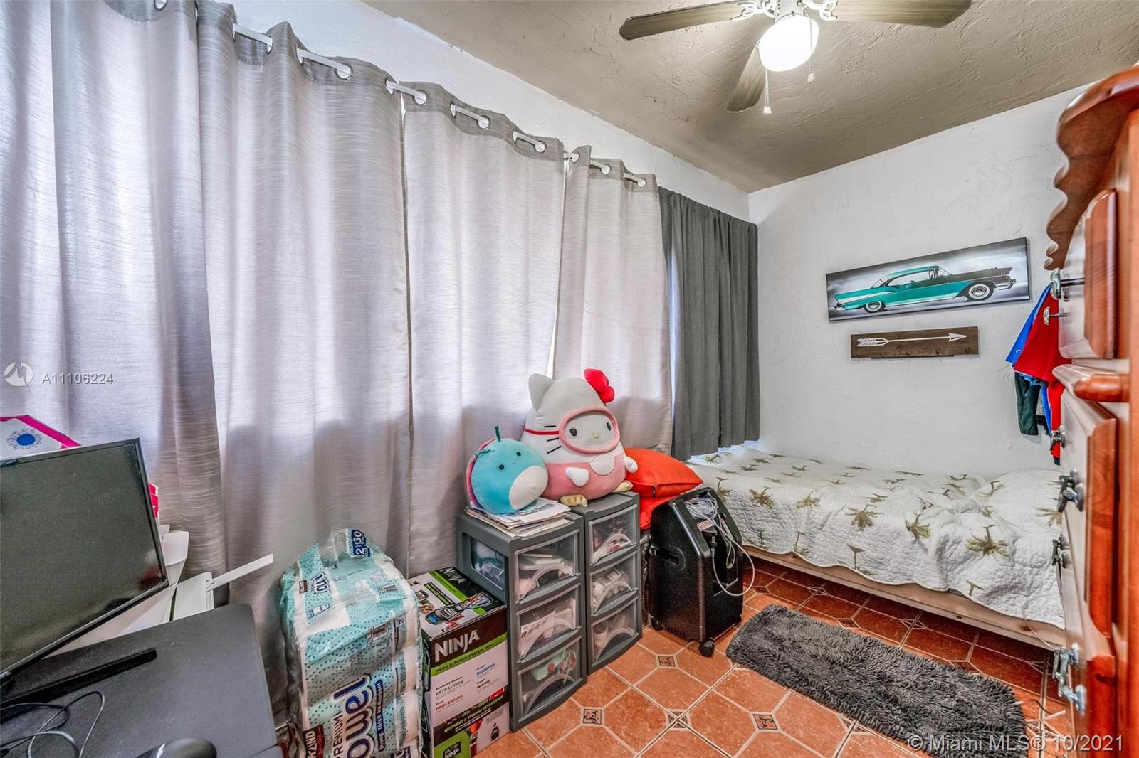 5720 Rock Island Road, Unit 391 Tamarac, FL 33319 - Photo 18 of 27 a bedroom with a bed and a window