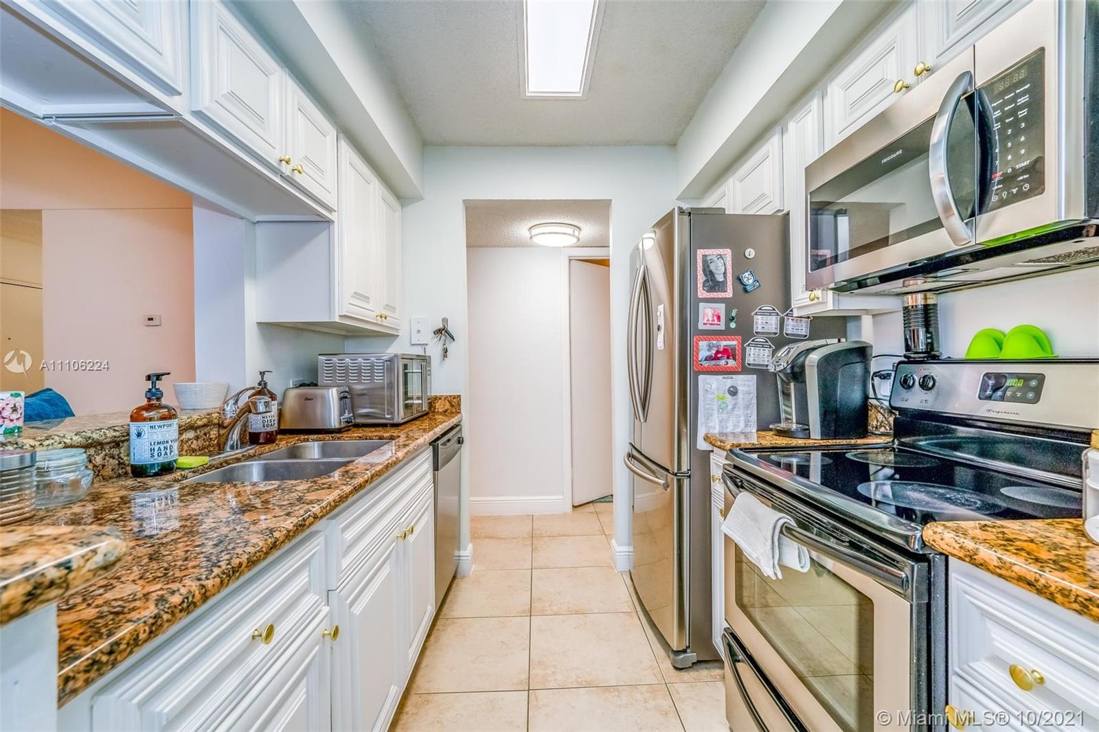 5720 Rock Island Road, Unit 391 Tamarac, FL 33319 - Photo 2 of 27 a kitchen with stainless steel appliances granite countertop a stove and a sink