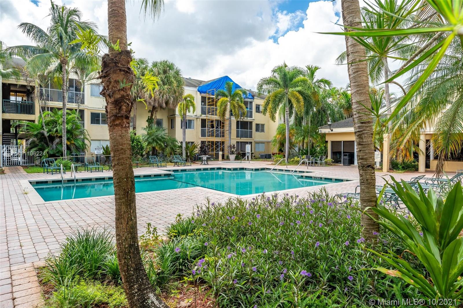 5720 Rock Island Road, Unit 391 Tamarac, FL 33319 - Photo 3 of 27 a view of a swimming pool with a garden and plants
