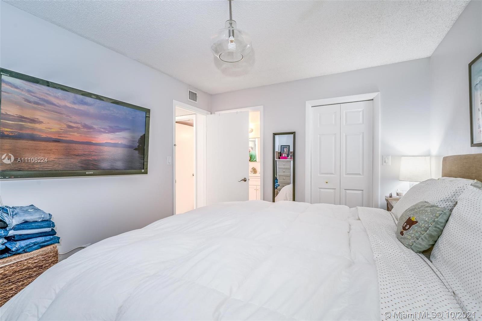 5720 Rock Island Road, Unit 391 Tamarac, FL 33319 - Photo 6 of 27 a bedroom with a bed and a painting on the wall