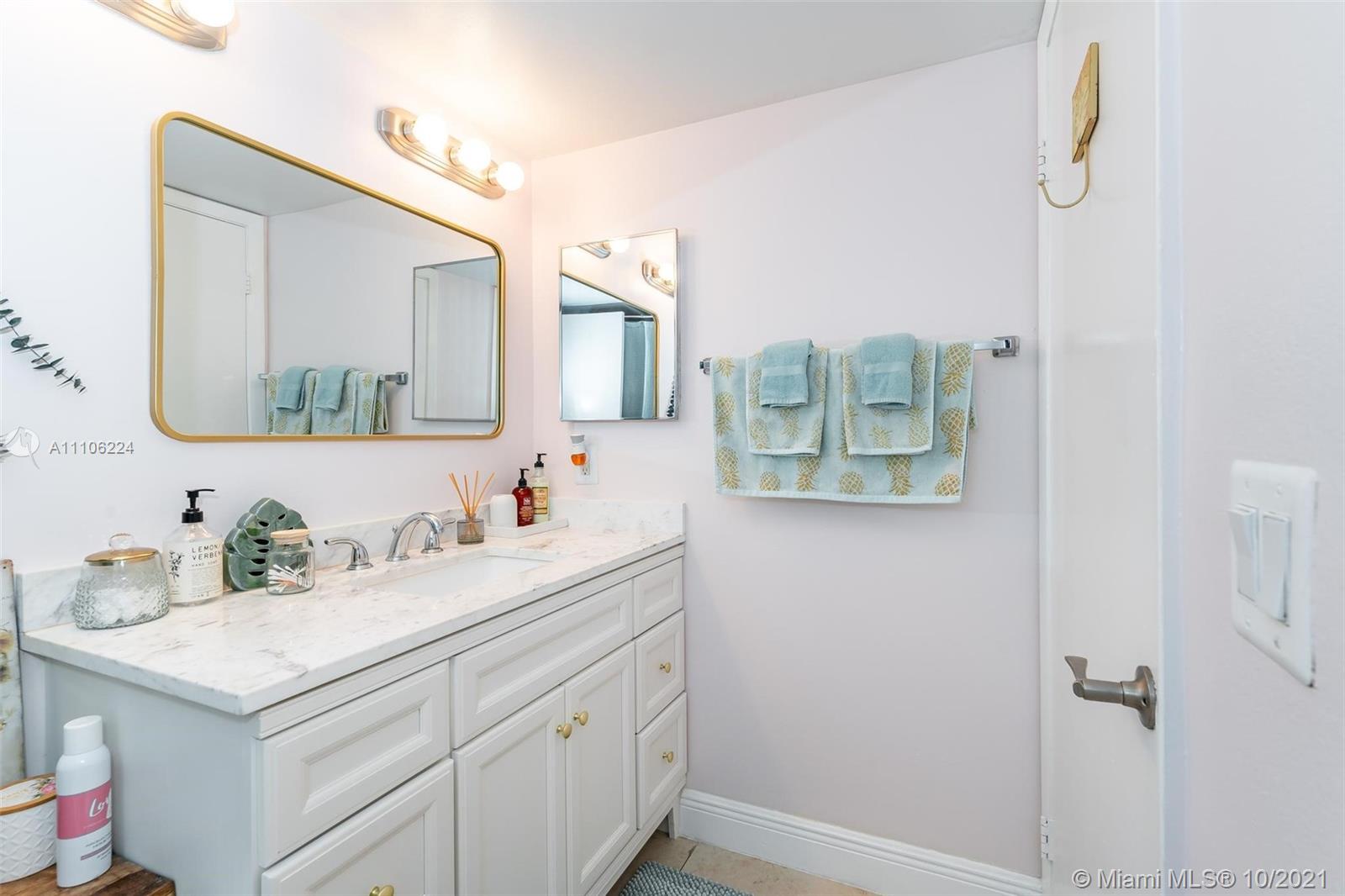 5720 Rock Island Road, Unit 391 Tamarac, FL 33319 - Photo 7 of 27 a bathroom with a sink and a mirror