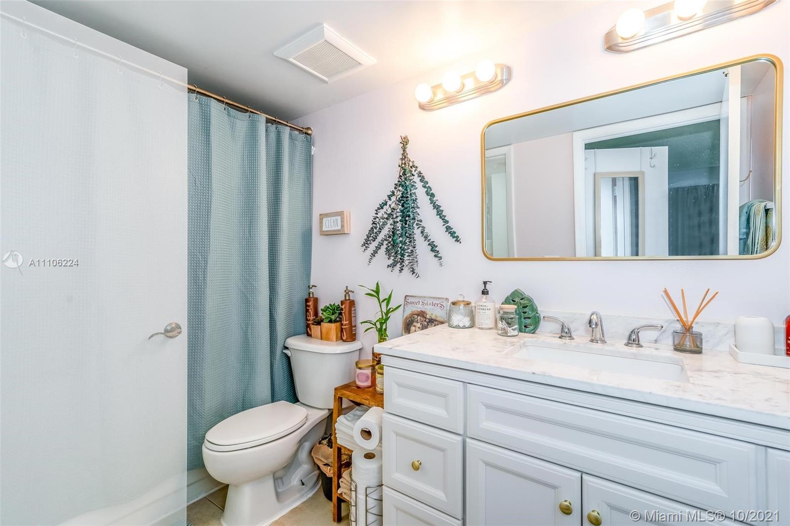 5720 Rock Island Road, Unit 391 Tamarac, FL 33319 - Photo 8 of 27 a bathroom with a sink a toilet and mirror