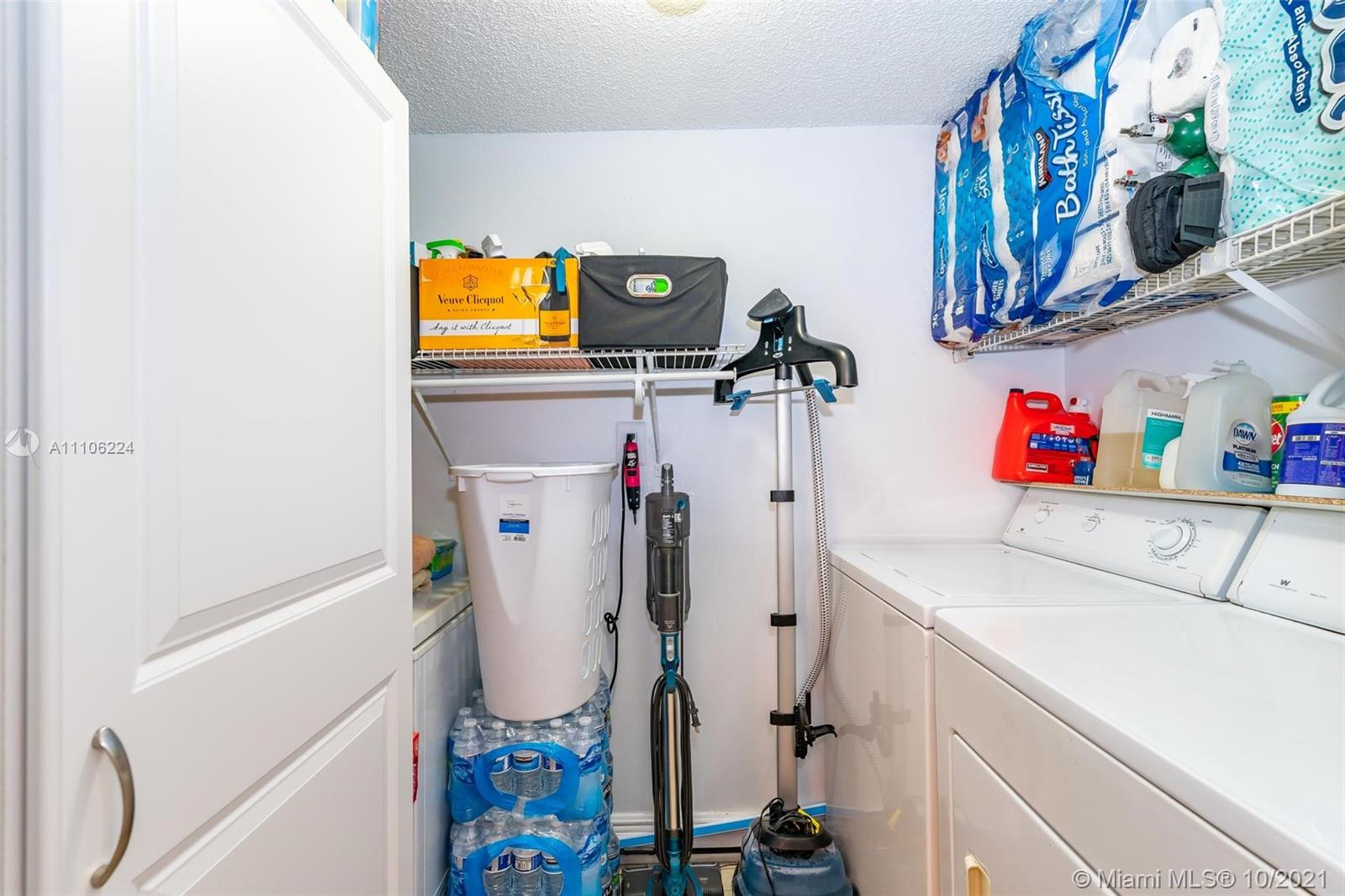 5720 Rock Island Road, Unit 391 Tamarac, FL 33319 - Photo 9 of 27 a utility room with dryer and washer