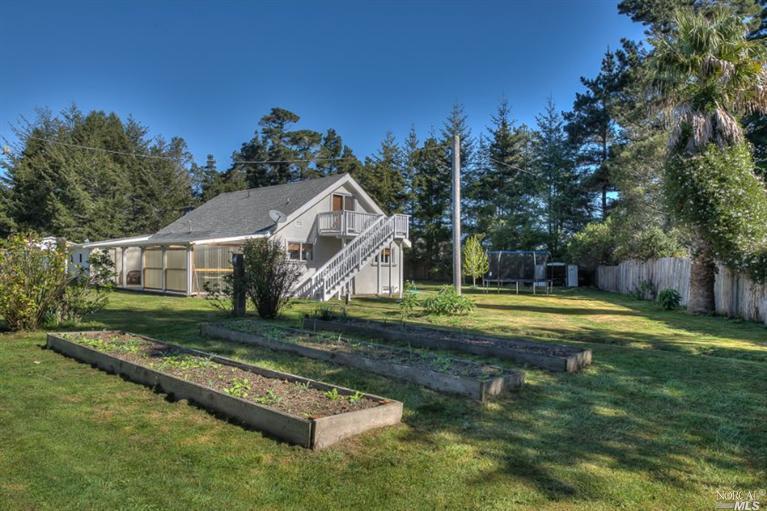24440 Tenmile Road Point Arena, CA 95468 - Photo 1 of 1 a view of a house with pool and a yard