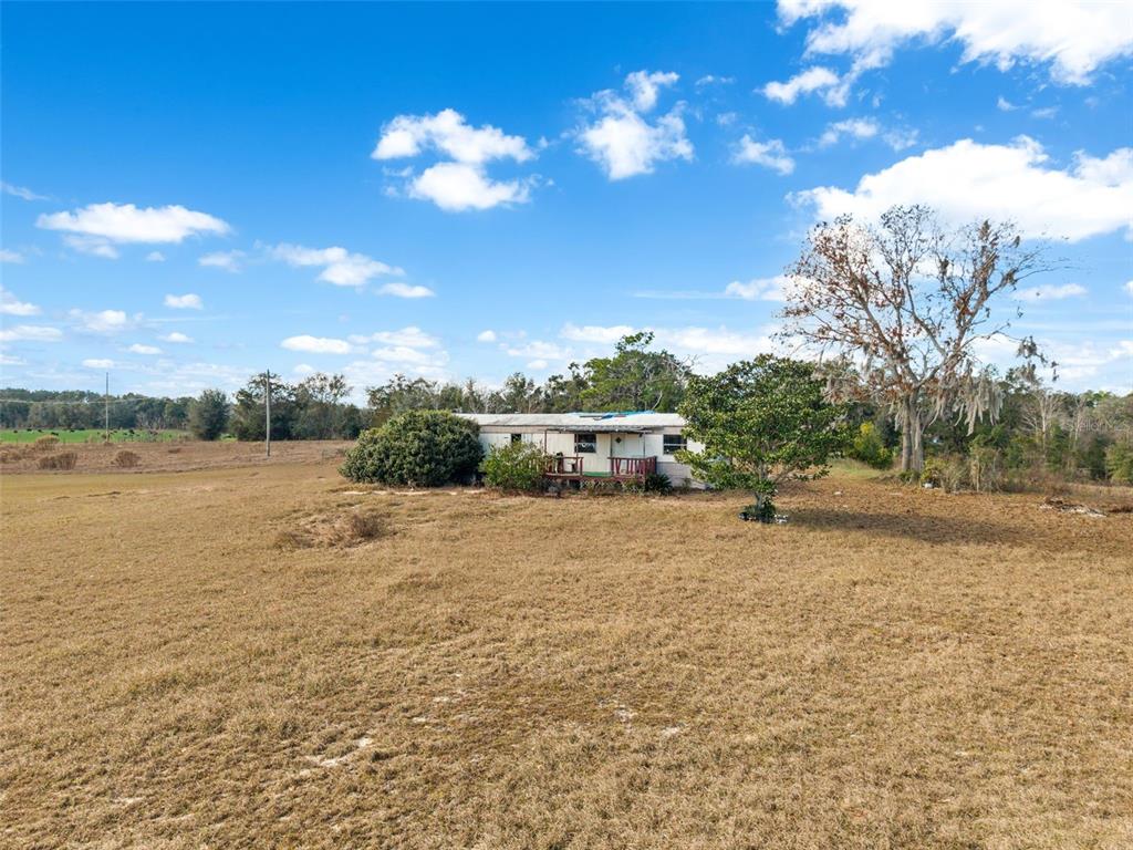 11406 Southwest 274 Street Newberry, FL 32669 - Photo 7 of 14 a backyard of a house with table and chairs