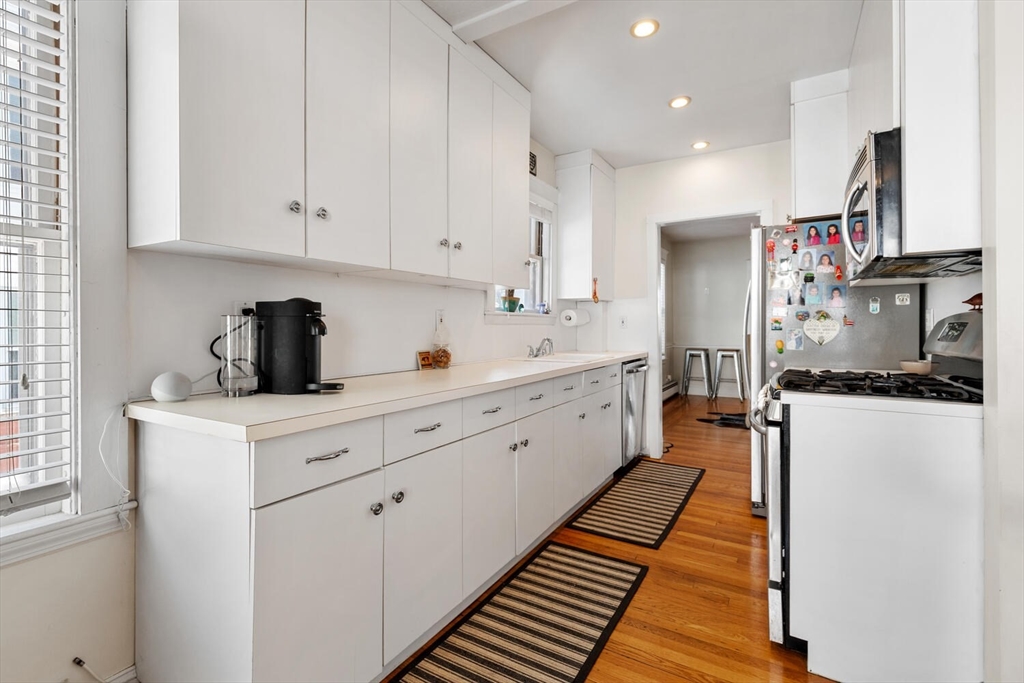 178 Norfolk Avenue, Unit 178 Swampscott, MA 01907 - Photo 16 of 33 a kitchen with white cabinets and appliances