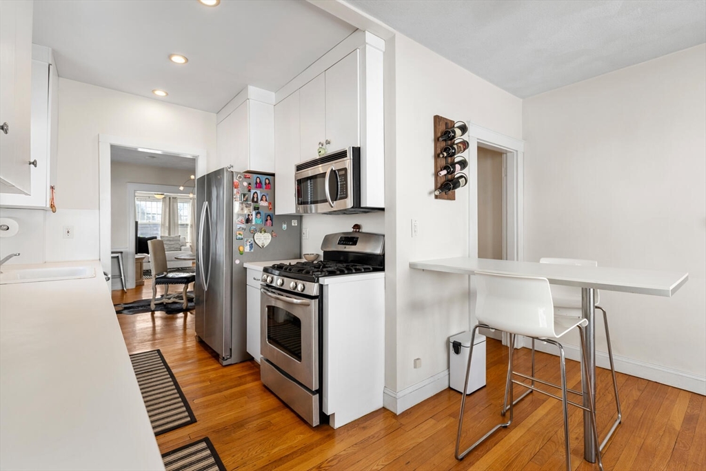 178 Norfolk Avenue, Unit 178 Swampscott, MA 01907 - Photo 17 of 33 a kitchen with granite countertop a refrigerator stove and sink