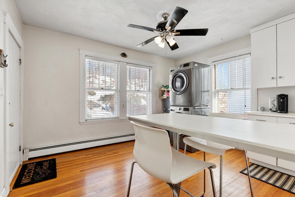 178 Norfolk Avenue, Unit 178 Swampscott, MA 01907 - Photo 19 of 33 a kitchen with a table chairs a sink and a window