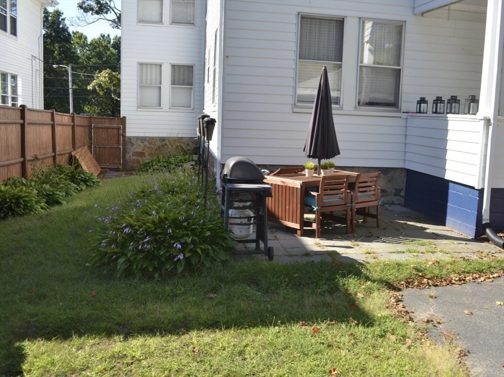 178 Norfolk Avenue, Unit 178 Swampscott, MA 01907 - Photo 29 of 33 a view of backyard with table and chairs