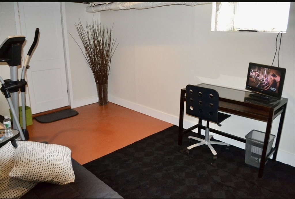 178 Norfolk Avenue, Unit 178 Swampscott, MA 01907 - Photo 31 of 33 a room with furniture and a rug