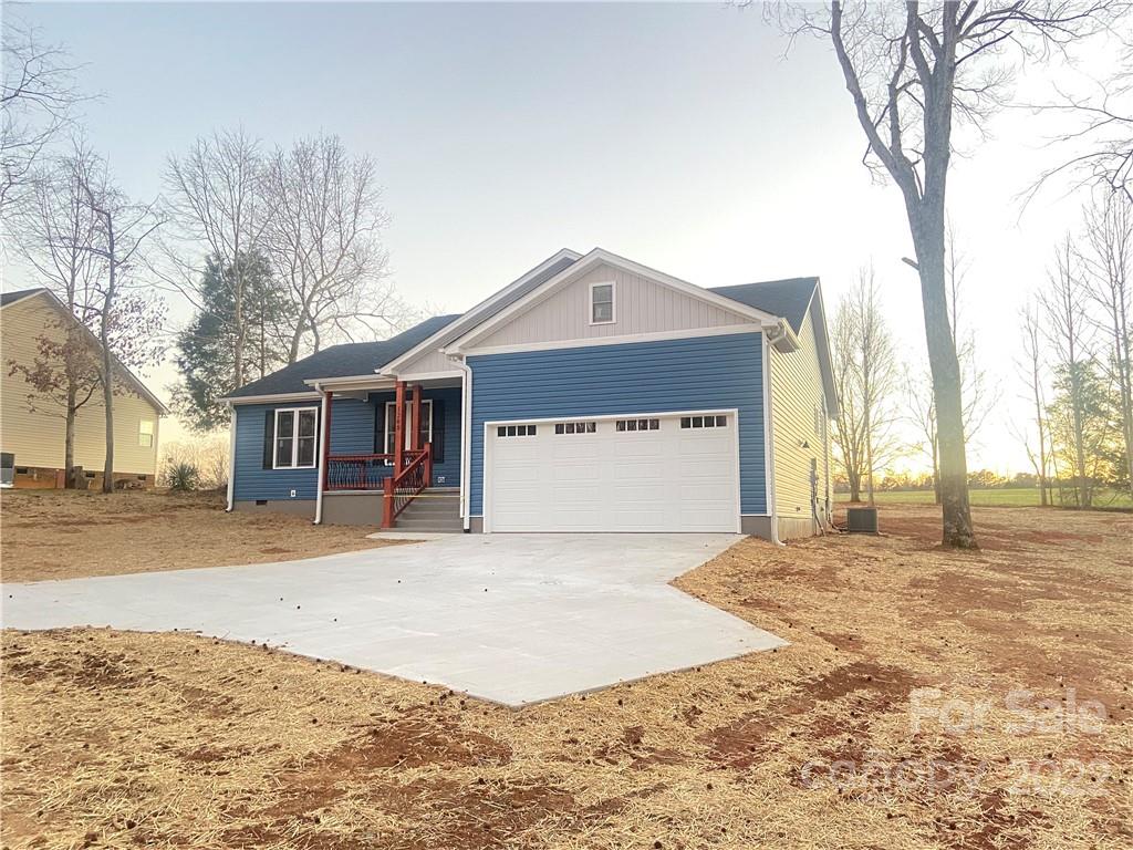 1208 Timber Spring Lane Salisbury, NC 28147 - Photo 1 of 19 a front view of a house with a yard and garage