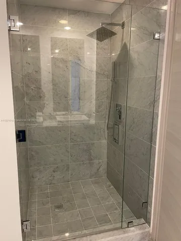 a bathroom with a granite countertop sink mirror and bathtub