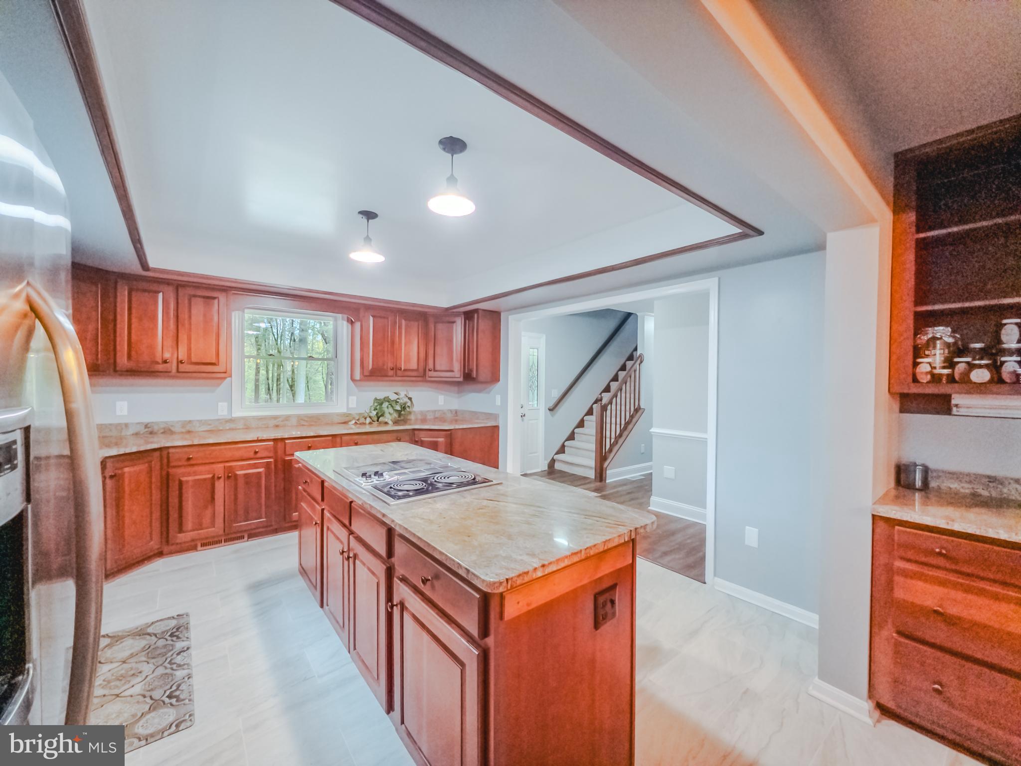 8749 Ramsburg Road Thurmont, MD 21788 - Photo 11 of 61 a kitchen with stainless steel appliances granite countertop a kitchen island a stove a sink and a refrigerator