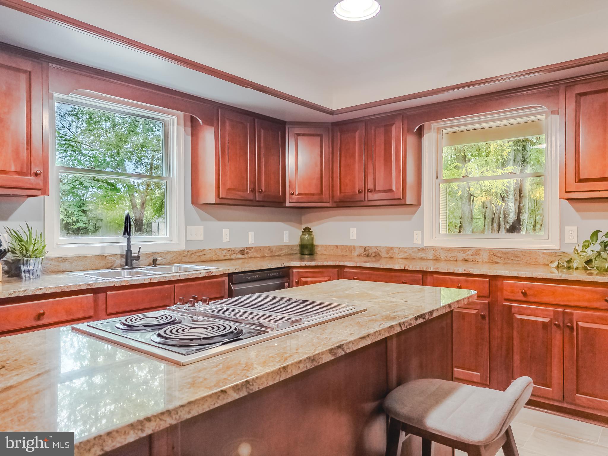 8749 Ramsburg Road Thurmont, MD 21788 - Photo 14 of 61 a kitchen with stainless steel appliances granite countertop a stove a sink and a white cabinets