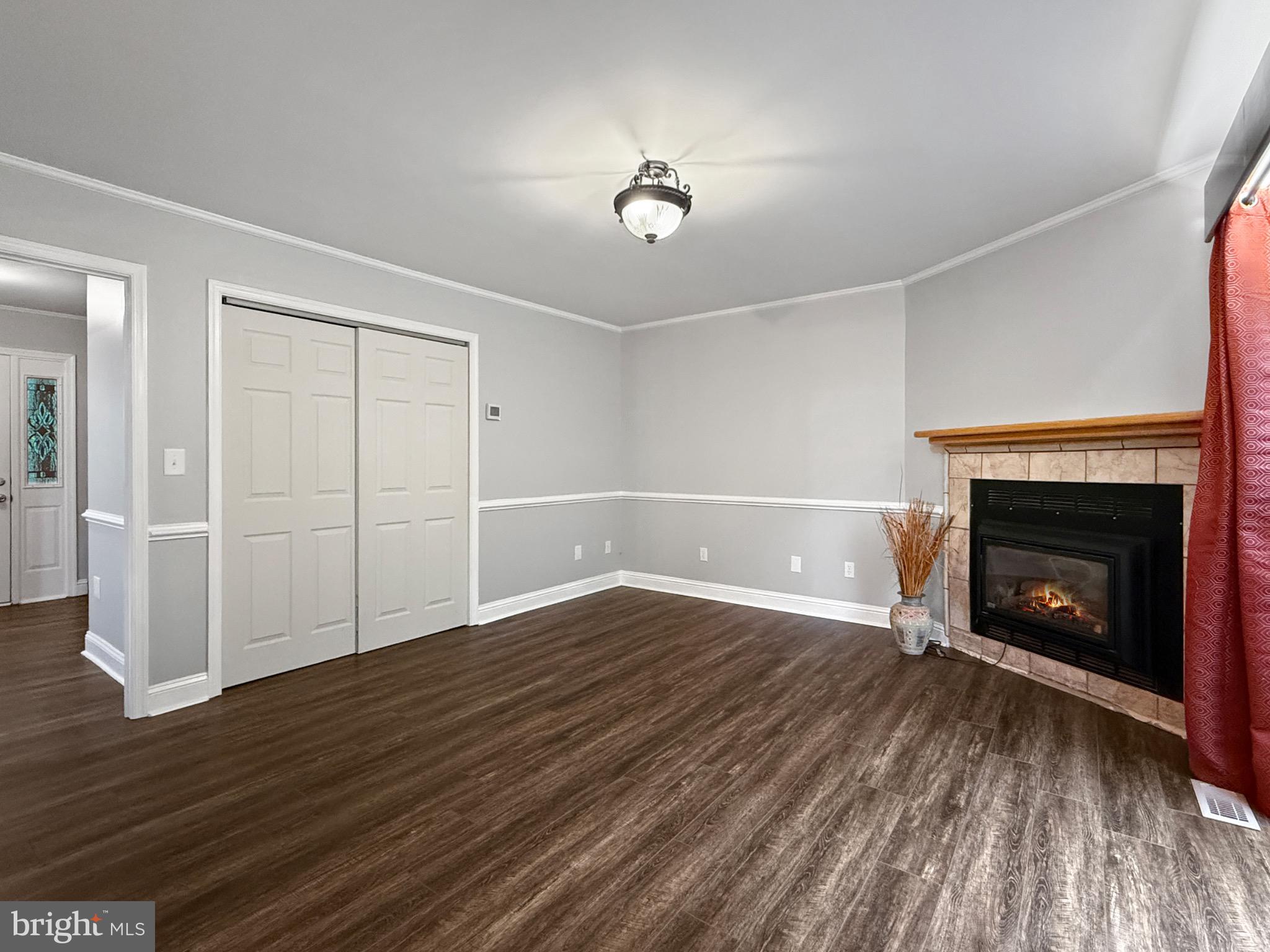 8749 Ramsburg Road Thurmont, MD 21788 - Photo 18 of 61 a view of an empty room with wooden floor fireplace and a window