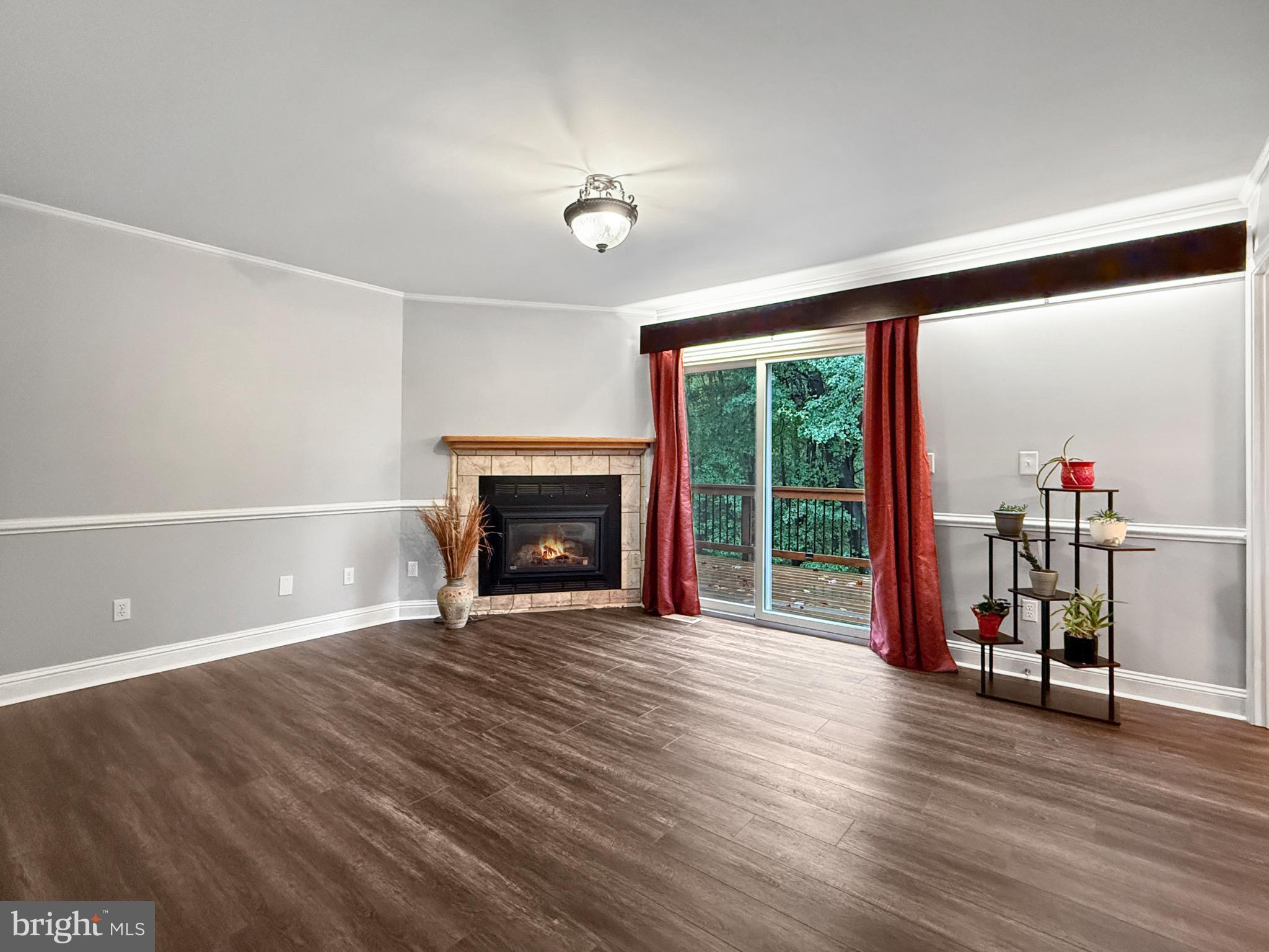 8749 Ramsburg Road Thurmont, MD 21788 - Photo 19 of 61 a view of a livingroom with wooden floor a fireplace and window