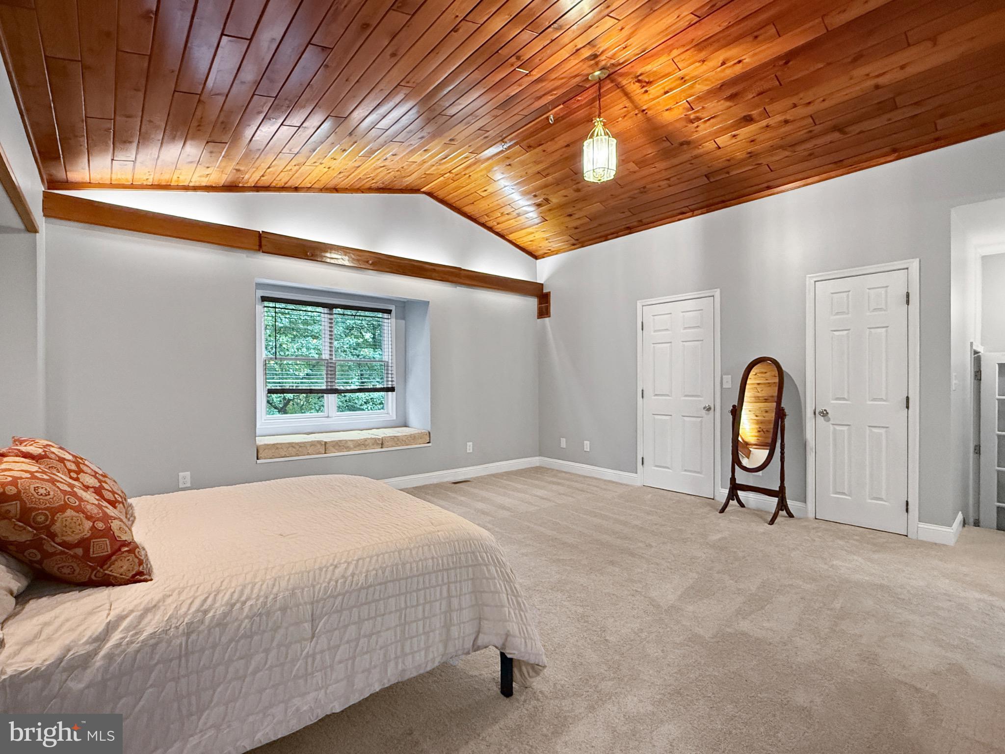 8749 Ramsburg Road Thurmont, MD 21788 - Photo 34 of 61 a bedroom with a bed and a chandelier