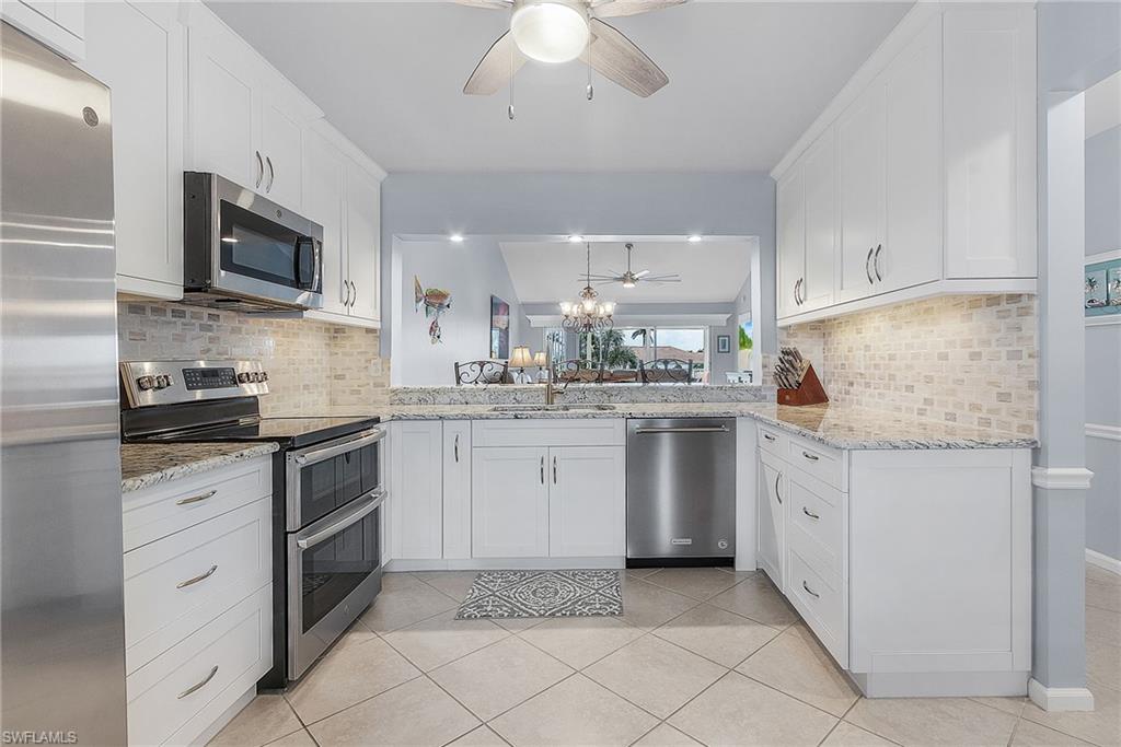 a kitchen with a sink stove and microwave