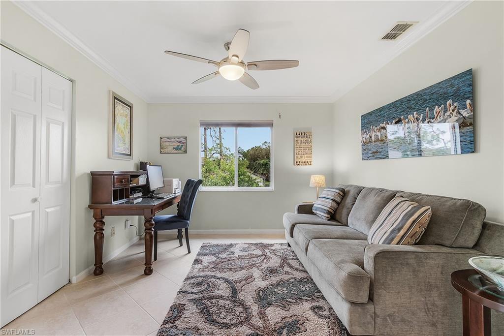 6780 Dennis Circle, Unit M206 Naples, FL 34104 - Photo 13 of 26 a living room with furniture and a window