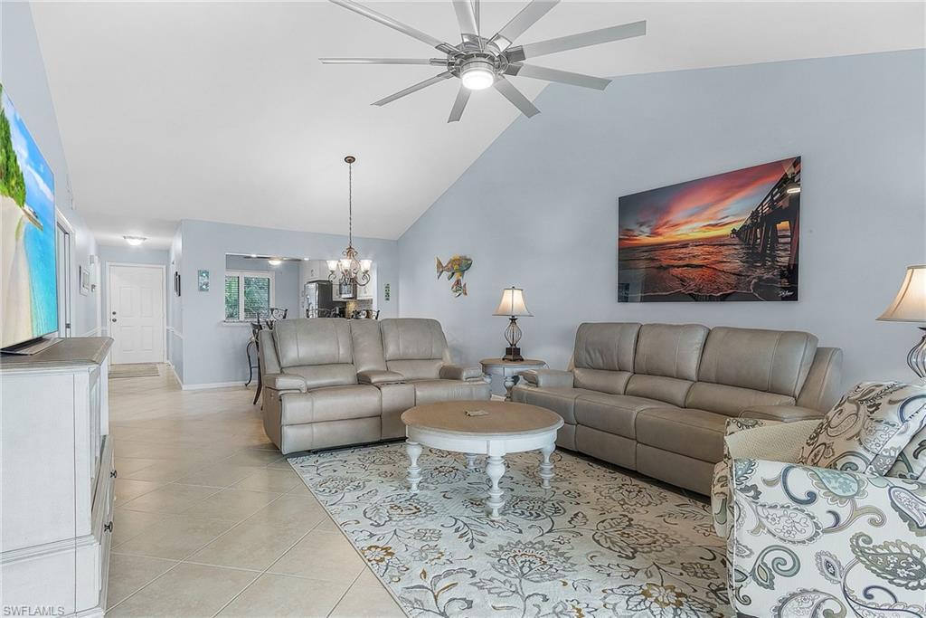 6780 Dennis Circle, Unit M206 Naples, FL 34104 - Photo 17 of 26 a living room with furniture and a chandelier