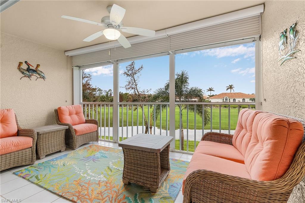 6780 Dennis Circle, Unit M206 Naples, FL 34104 - Photo 19 of 26 a living room with furniture a floor to ceiling window and a flat screen tv