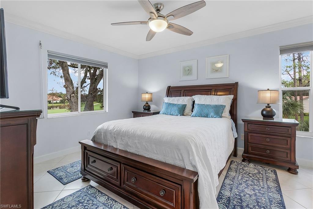 6780 Dennis Circle, Unit M206 Naples, FL 34104 - Photo 21 of 26 a bedroom with a bed and a window