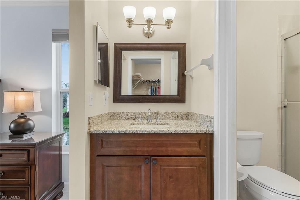 6780 Dennis Circle, Unit M206 Naples, FL 34104 - Photo 23 of 26 a bathroom with a sink and a toilet