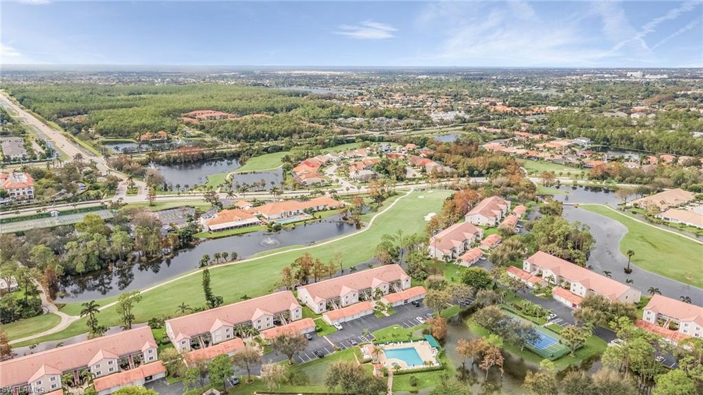 6780 Dennis Circle, Unit M206 Naples, FL 34104 - Photo 26 of 26 an aerial view of ocean and residential houses with outdoor space