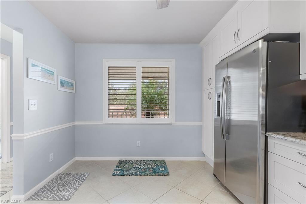 6780 Dennis Circle, Unit M206 Naples, FL 34104 - Photo 5 of 26 a bathroom with a bathtub and shower