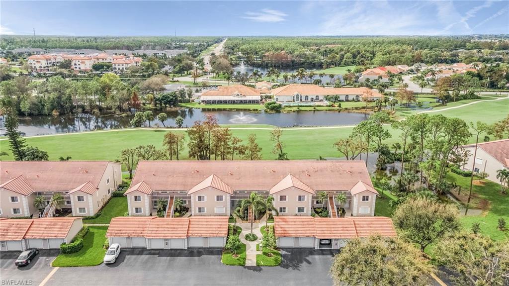 6780 Dennis Circle, Unit M206 Naples, FL 34104 - Photo 7 of 26 an aerial view of residential houses with outdoor space and trees