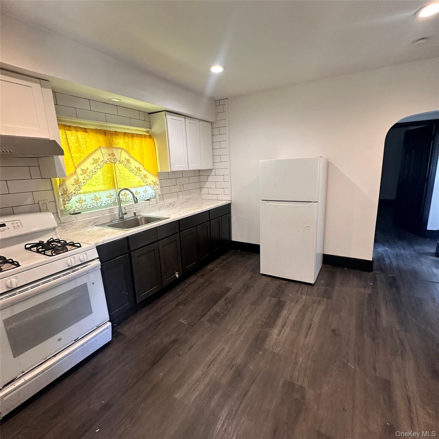 152 Smith Street, Unit 2 Poughkeepsie, NY 12601 - Photo 6 of 8 Vinyl flooring, recess lighting, gas range, exhaust fan, refrigerator.