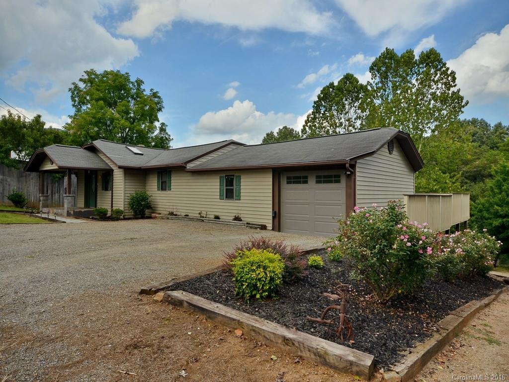 442 Thompson Cove Road Clyde, NC 28721 - Photo 1 of 20 a front view of a house with garden