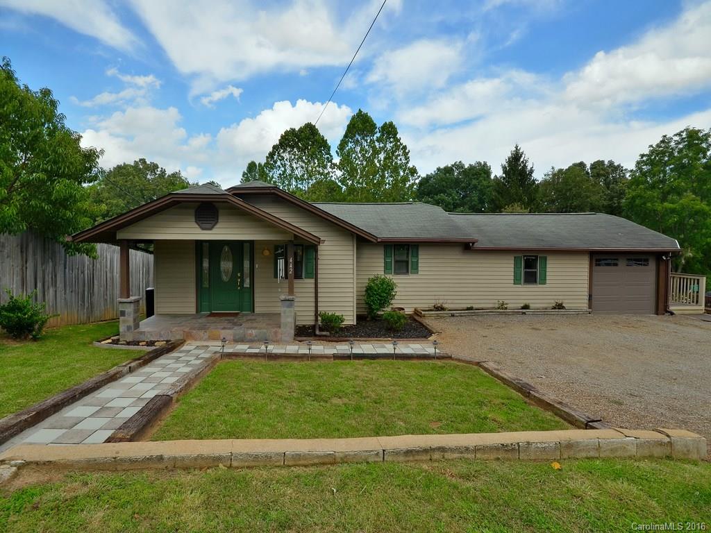 442 Thompson Cove Road Clyde, NC 28721 - Photo 2 of 20 a front view of a house with a garden and trees