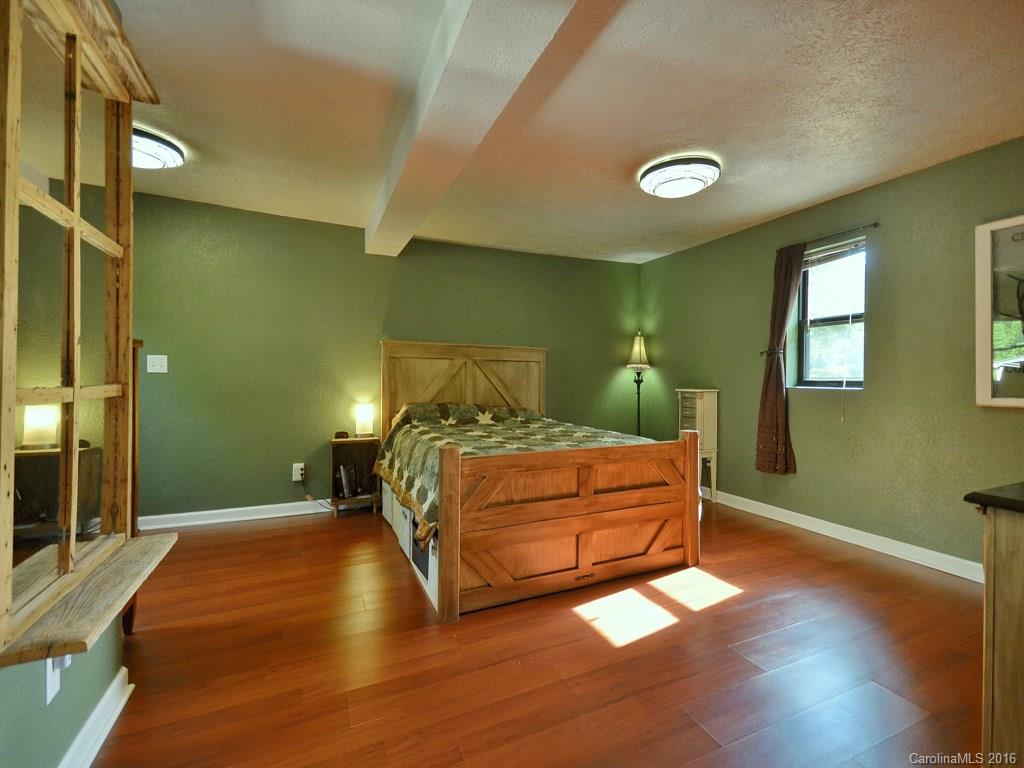 442 Thompson Cove Road Clyde, NC 28721 - Photo 11 of 20 a bedroom with a bed and window