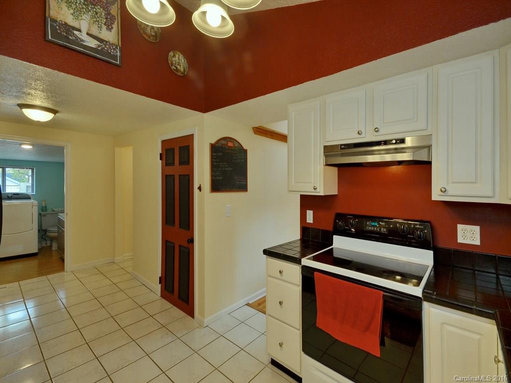 442 Thompson Cove Road Clyde, NC 28721 - Photo 14 of 20 a kitchen with stainless steel appliances granite countertop a stove a refrigerator and a microwave