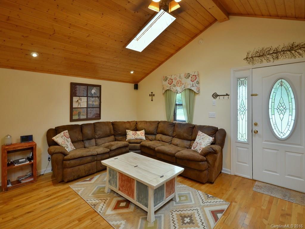442 Thompson Cove Road Clyde, NC 28721 - Photo 3 of 20 a living room with furniture and a clock