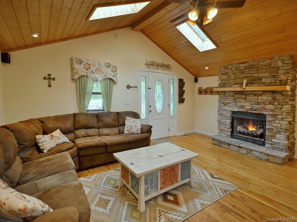 442 Thompson Cove Road Clyde, NC 28721 - Photo 4 of 20 a living room with furniture and a fireplace